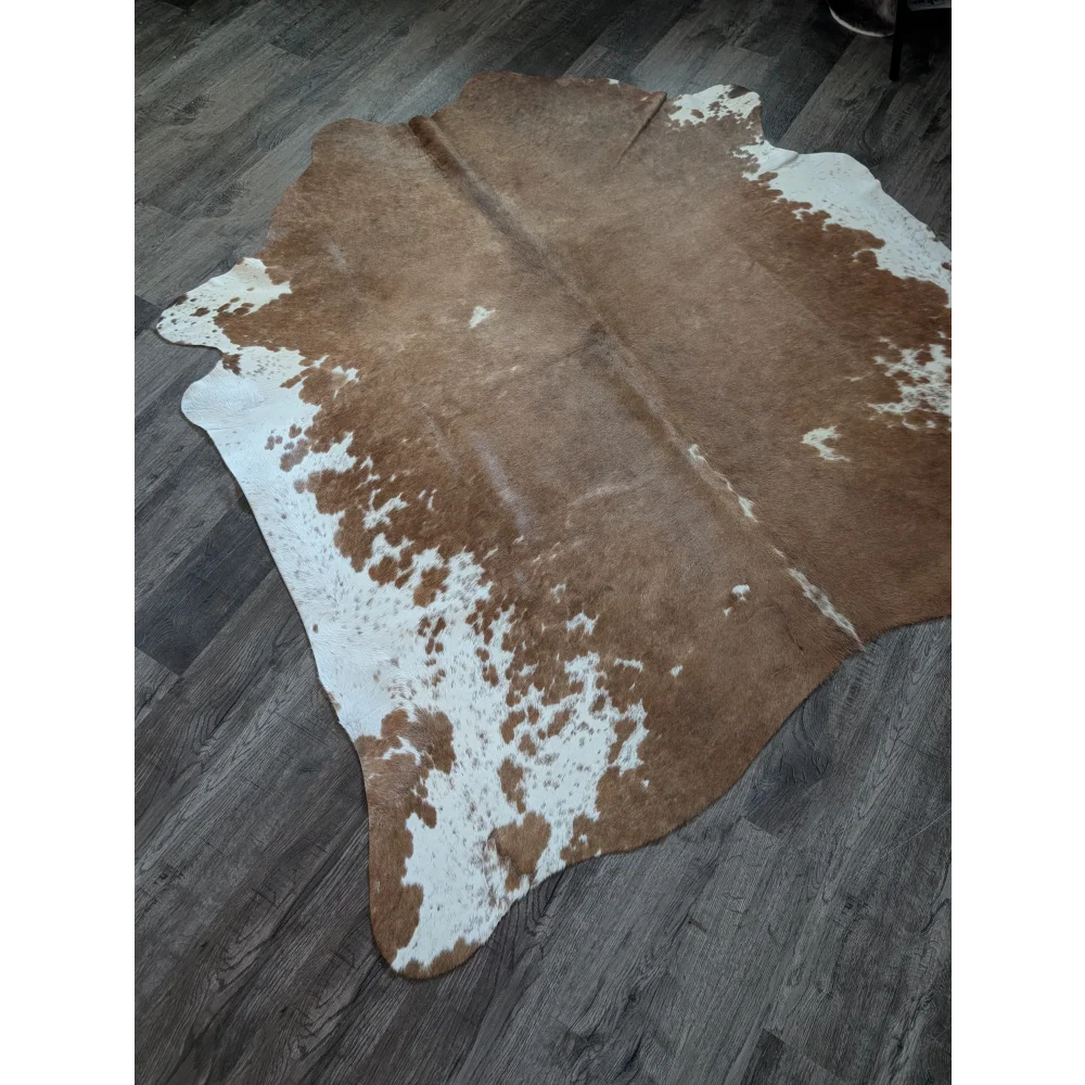Brown and white large cowhide rug with natural irregular patches perfect for beautiful rugs and home decor