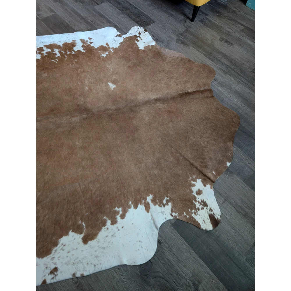 Brown and white large cowhide rug with natural irregular edges perfect for beautiful rugs and cozy spaces