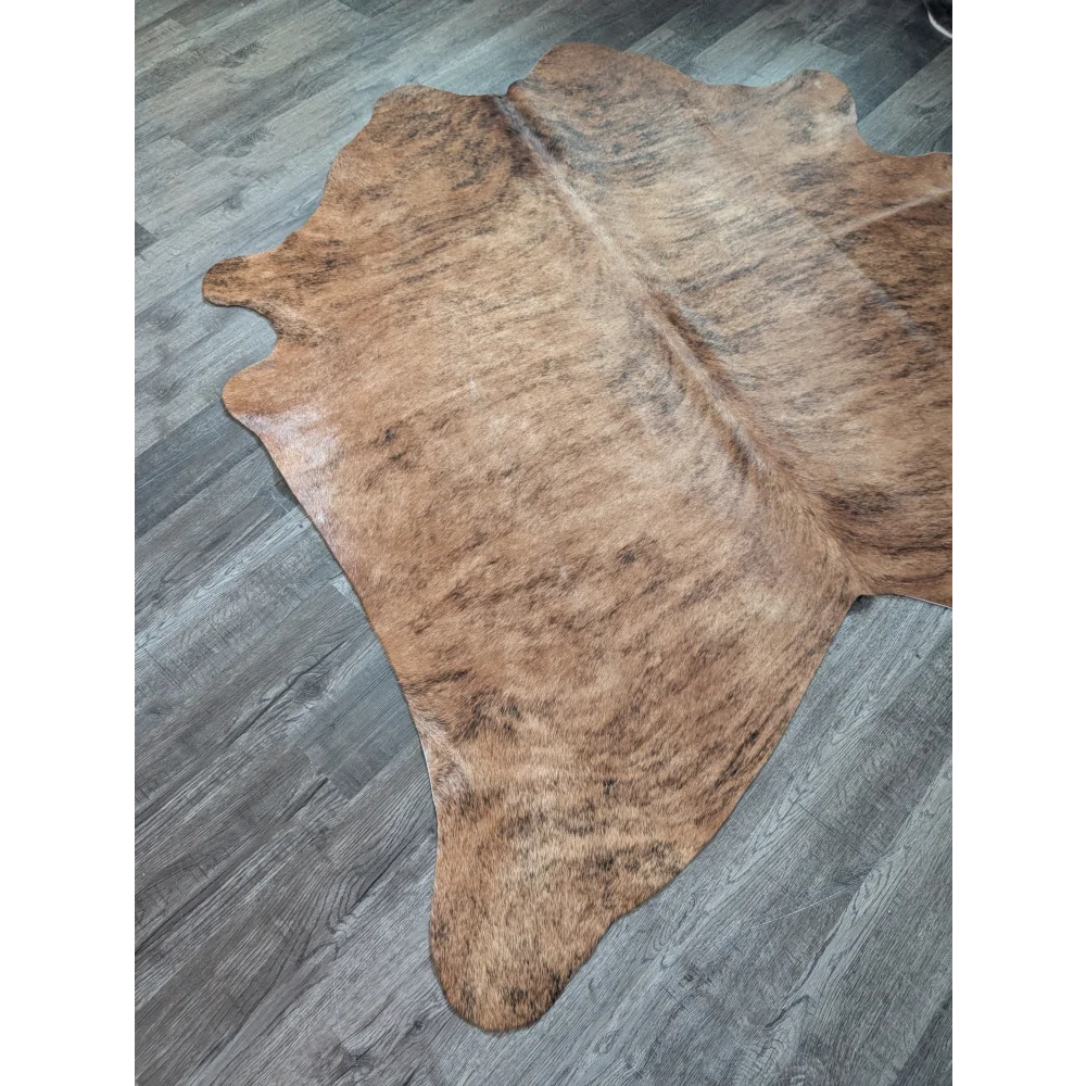 Brown and tan large cowhide rug with natural irregular edges perfect for beautiful rugs and home decor