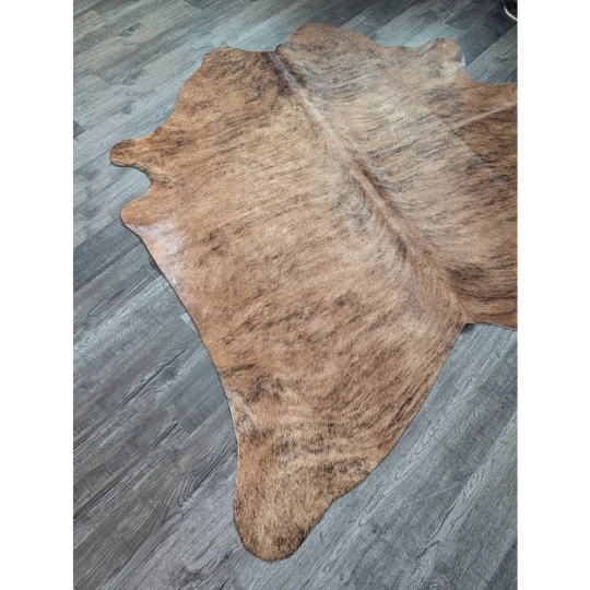 Brown and tan large cowhide rug with natural irregular edges perfect for beautiful rugs and home decor