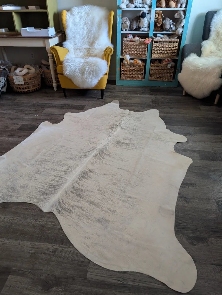 Es#11 large cowhide rug with natural tones and soft texture featuring subtle grayish markings perfect for beautiful rugs