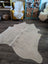 Es#11 large cowhide rug with natural tones and soft texture featuring subtle grayish markings perfect for beautiful rugs
