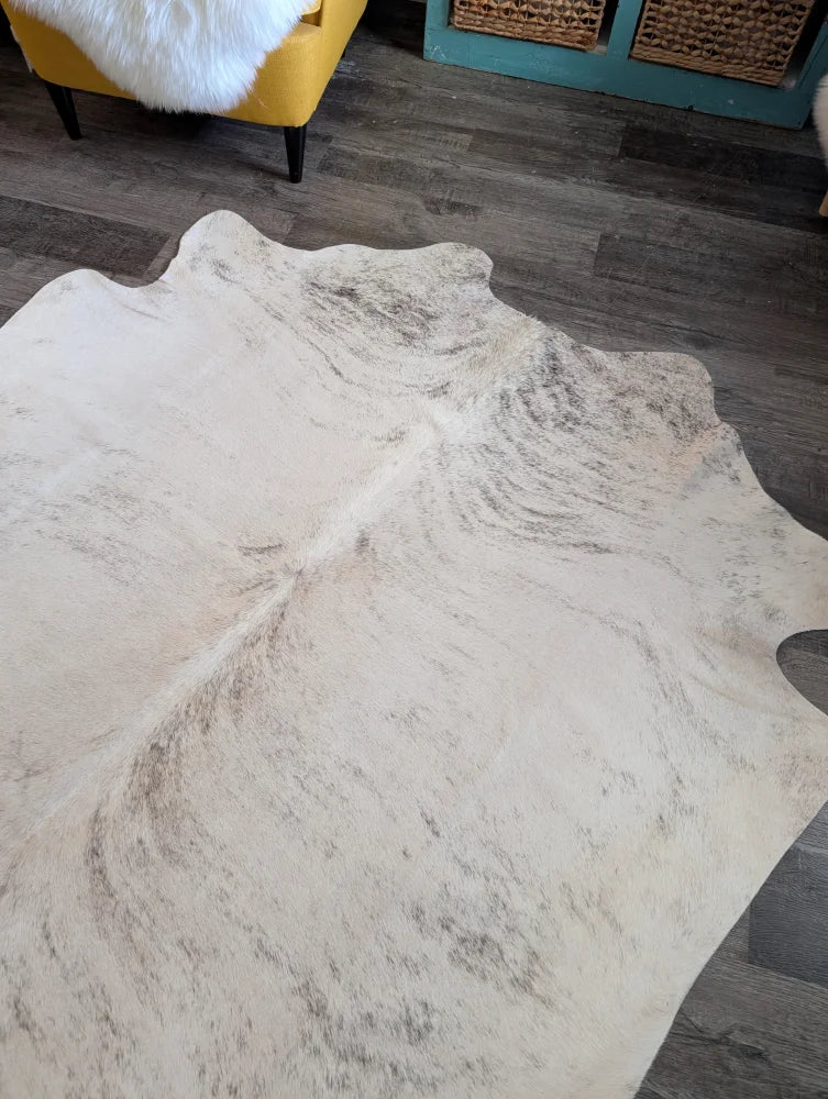 Large cowhide rug es24 with natural tones and soft textured surface featuring subtle grayish brown markings
