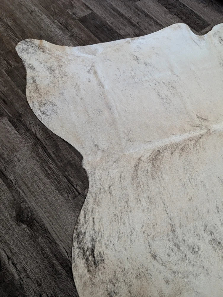 Large cowhide rug in white and gray speckled natural edges perfect for beautiful rugs and home decor