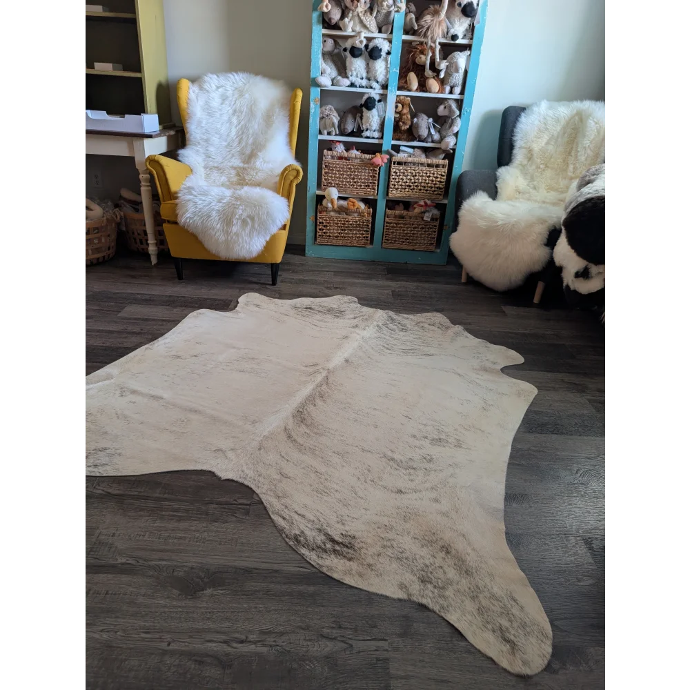 Cream-colored large cowhide rug es24 with natural edges and subtle dark speckling perfect for beautiful rugs