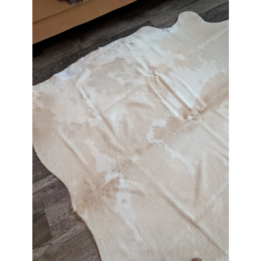 A large cowhide rug es703 in natural white and beige with a soft textured surface perfect beautiful rugs