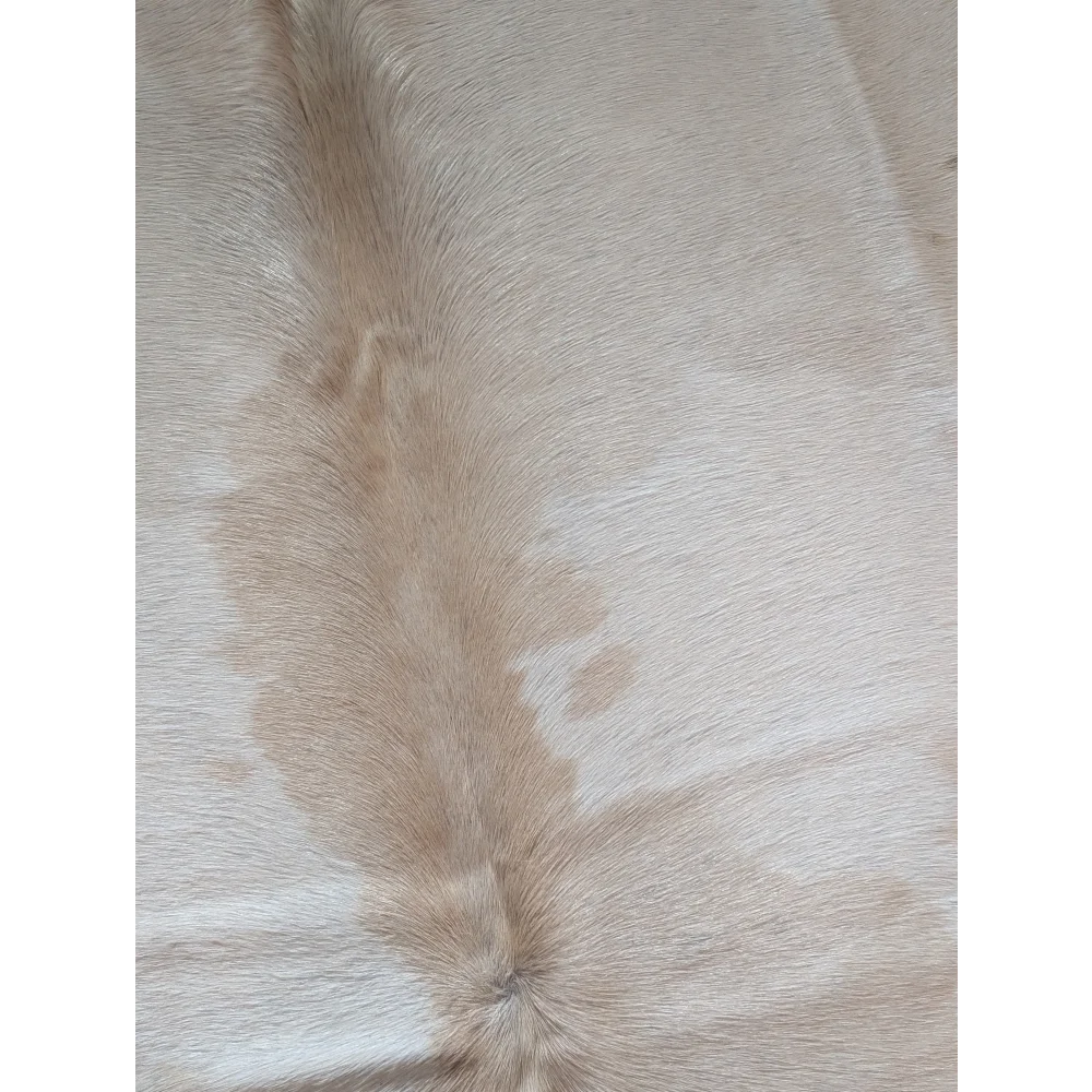 Beige large cowhide rug with natural textured fur and subtle tan markings perfect for beautiful rugs lovers