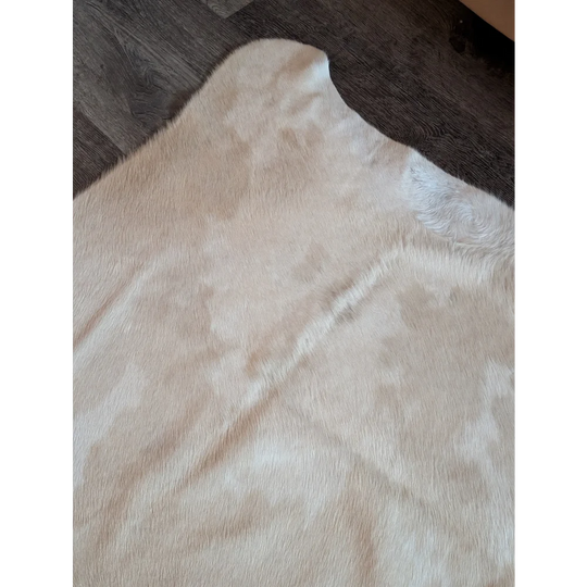 Cream-colored large cowhide rug es703 with soft natural fur and subtle tone variations perfect among beautiful rugs