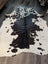 Large cowhide rug es#706 with unique black and white natural patches on a creamy base measuring 78 x 68 inches