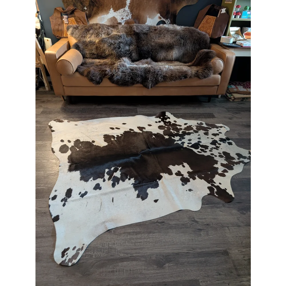 Large cowhide rug es#706 with unique black and white spotted pattern measuring 78 by 68 inches