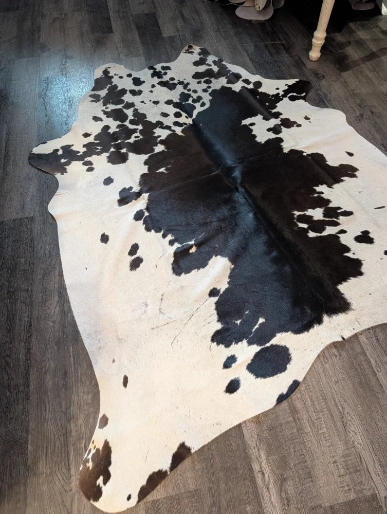 Large cowhide rug es706 with black and white natural irregular patches showcasing unique characteristics