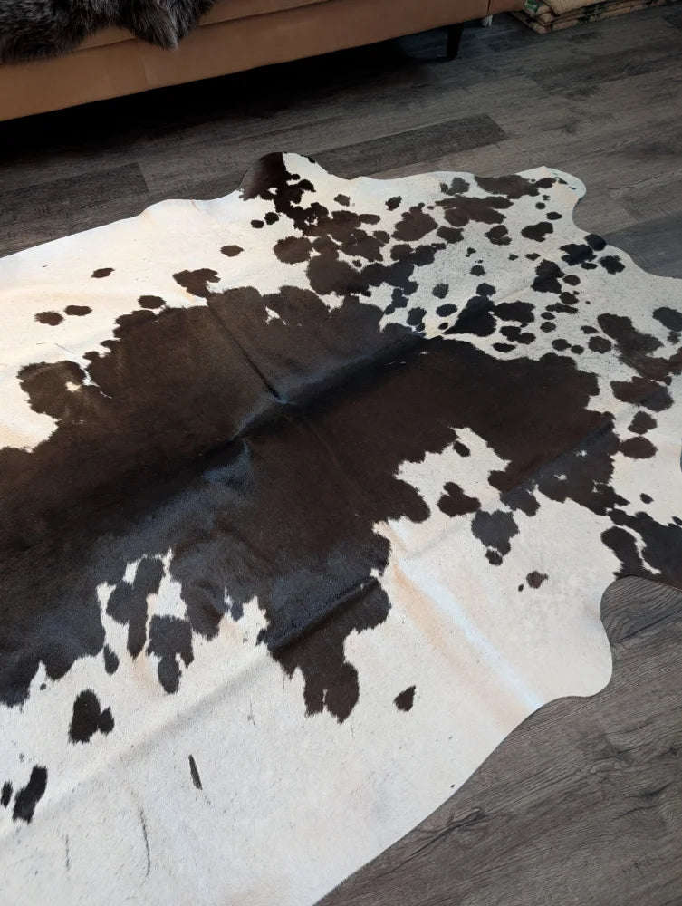 Large cowhide rug es706 with unique black white and dark brown spotted pattern on creamy off white base
