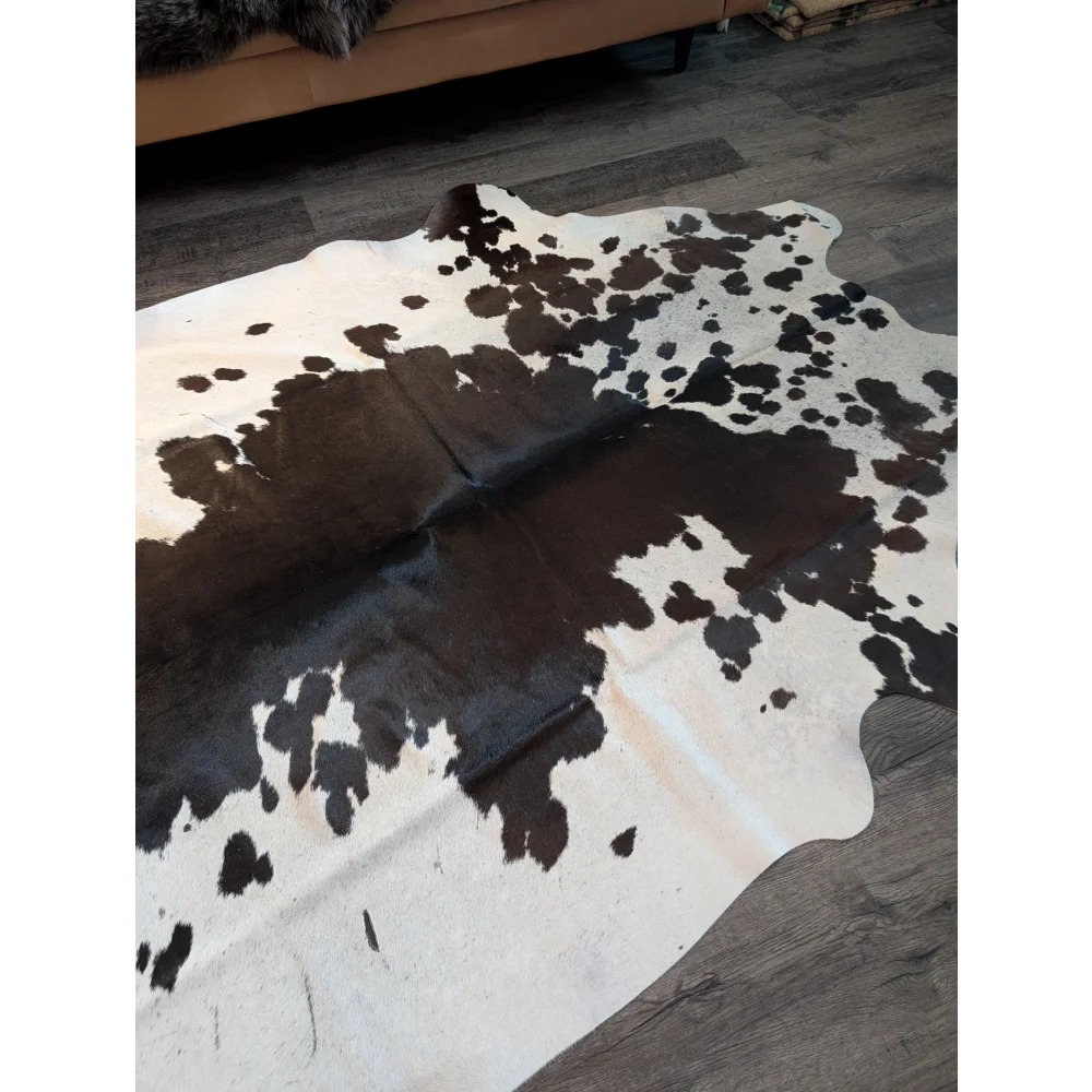 Large cowhide rug es706 with unique black white and dark brown spotted pattern on creamy off white base
