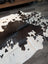 Large cowhide rug es706 with unique black white and dark brown spotted pattern on creamy off white base
