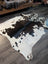 Large cowhide rug es706 with a striking black and white spotted pattern and unique organic shape perfect for any room