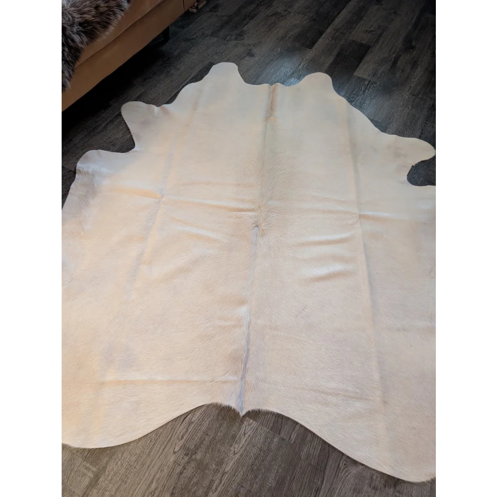 Large cream cowhide rug with natural shape and soft texture perfect for beautiful rugs and home decor
