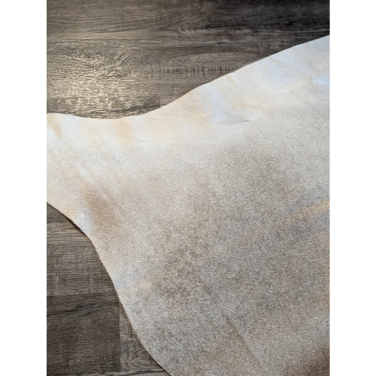 Large beautiful cowhide rug es708 features an off-white soft texture with natural grain and subtle tone variations