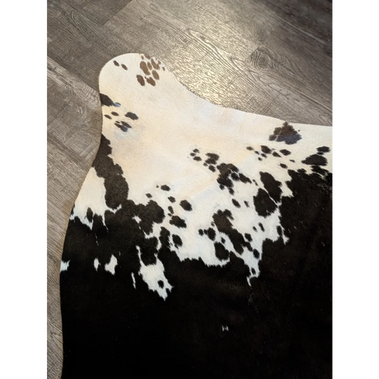 Large cowhide rug es711 with black and white cowhide and natural irregular dark brown spots, perfect for beautiful rugs