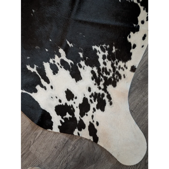 Large cowhide rug with natural black and white irregular patches perfect for beautiful rugs and home decor