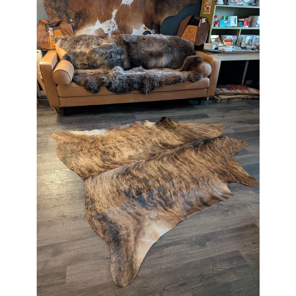 Large cowhide rug with brown and black brindle natural fur texture showcasing unique characteristics laid flat