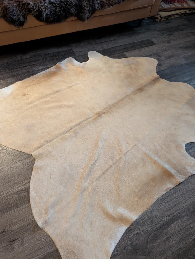 Natural tan large cowhide rug with unique characteristics soft textured surface and irregular edges es717 73 x 73