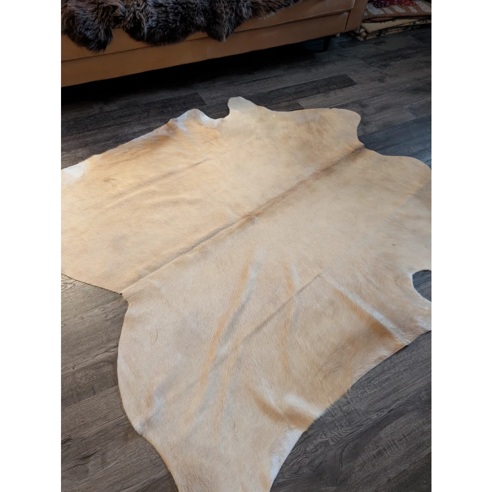 Natural tan large cowhide rug with unique characteristics soft textured surface and irregular edges es717 73 x 73