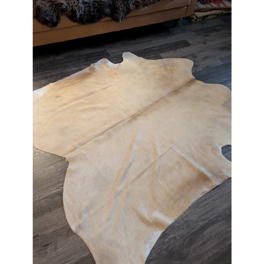 Natural tan large cowhide rug with unique characteristics soft textured surface and irregular edges es717 73 x 73