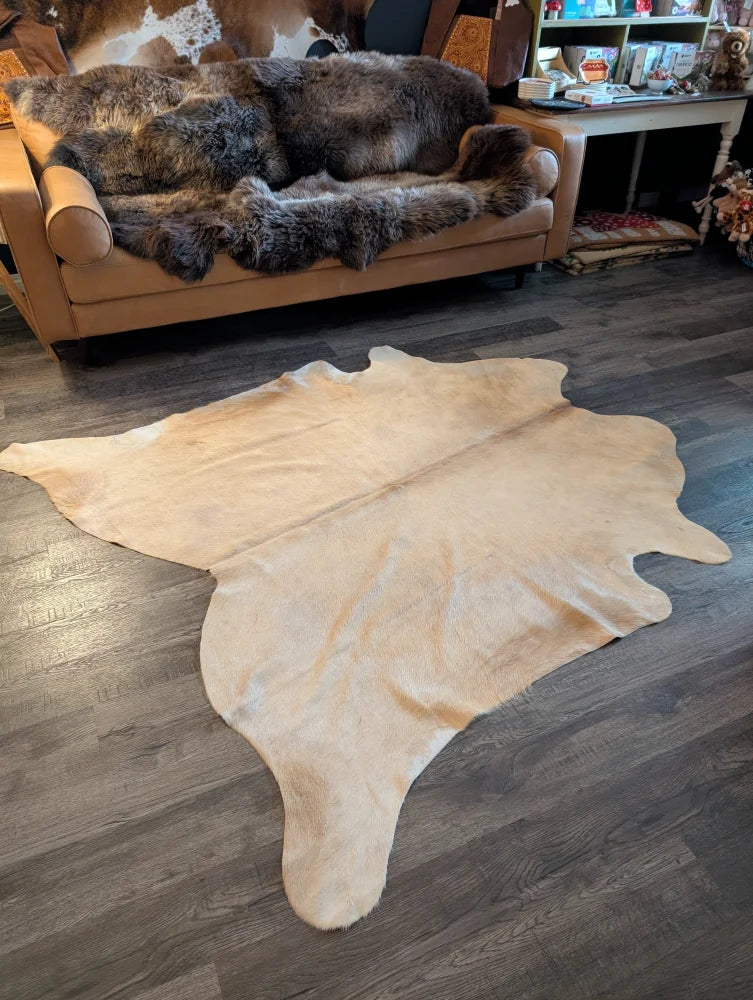 Beige large cowhide rug es717 with unique characteristics natural irregular edges and soft textured surface