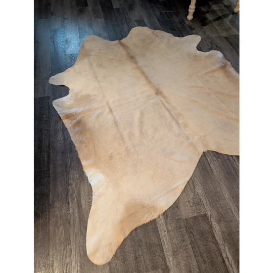 Natural tan large cowhide rug es717 with soft fuzzy texture and unique irregular edges perfect for home decor