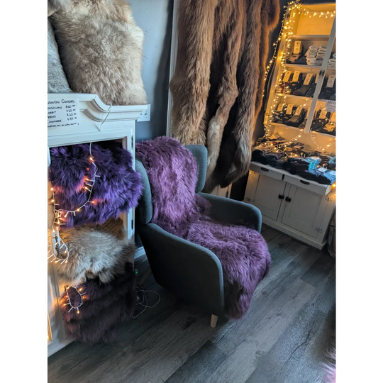 Purple faux fur armchair with black frame and wooden legs, eco friendly methods