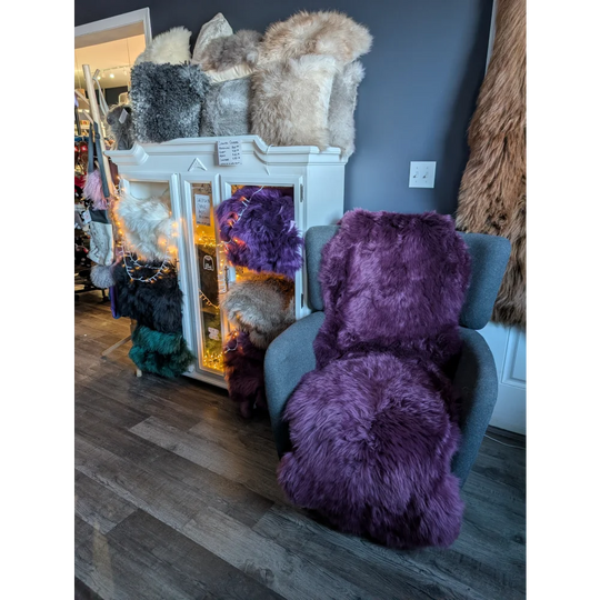 Plush purple faux fur armchair with gorgeous merino sheepskin rug vibes