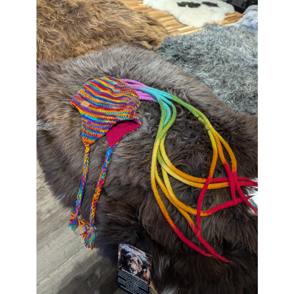 Colorful knitted rainbow Rasta hat with earflaps and rainbow braided ties