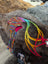 Colorful knitted rainbow Rasta hat with earflaps and rainbow braided ties