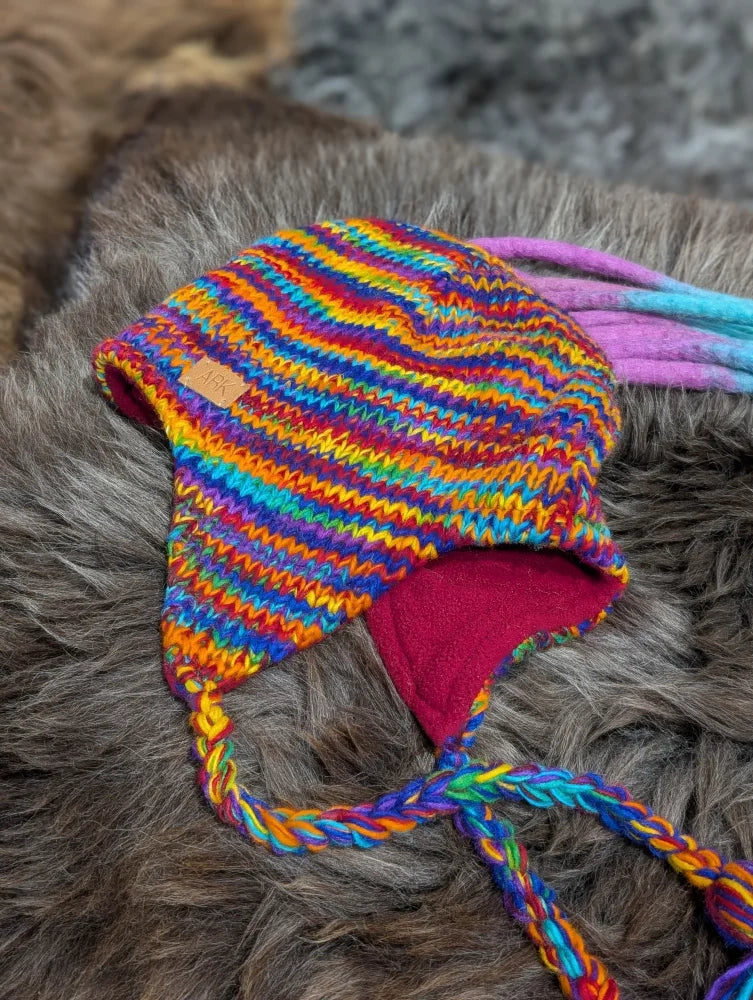 Colorful rainbow rasta hat with fleece lining and braided ties, perfect rasta hat style