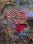 Colorful rainbow rasta hat with fleece lining and braided ties, perfect rasta hat style