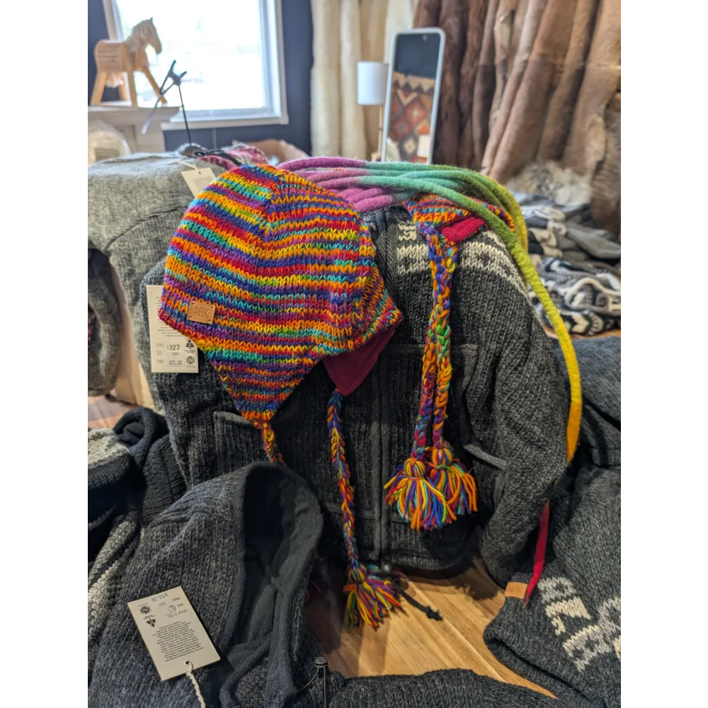 Colorful rainbow Rasta hat with ear flaps and braided ties, perfect as a rasta hat