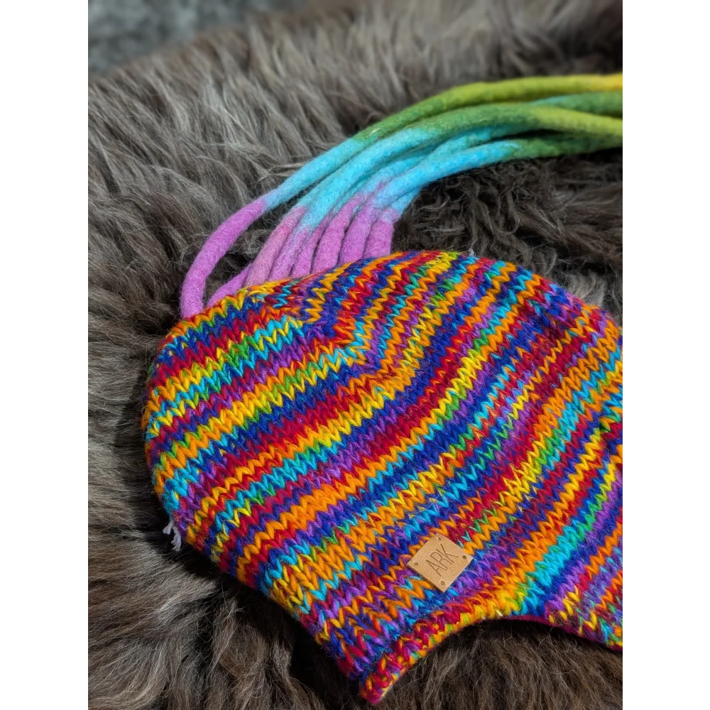 Colorful rainbow rasta hat with knit stripes and dreadlock tassels for a cool look
