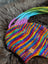 Colorful rainbow rasta hat with knit stripes and dreadlock tassels for a cool look