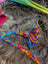 Colorful braided yarn tassel and cord on a Rainbow Rasta Hat for a fun look