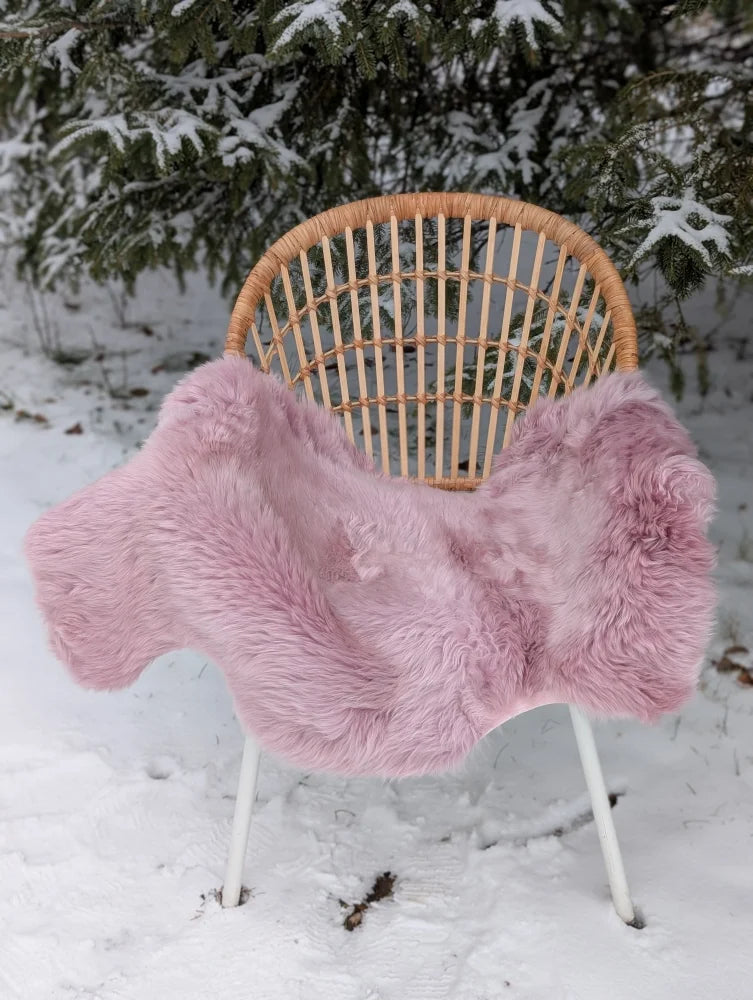 Fairy pink merino sheepskin soft fluffy pink merino sheepskin rug draped over wicker chair reach standards