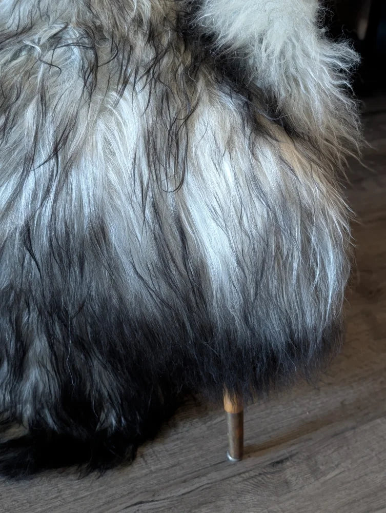 A plush long wool icelandic faux fur coat in gradient white to black with brown tones from massive icelandic sheepskins