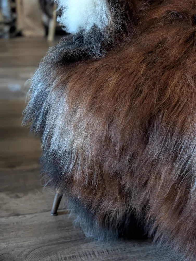 A plush 57 by 40 inch massive natural dark rusty icelandic sheepskin throw in rich brown gray wool icelandic tones
