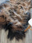 A plush tri color natural dark rusty icelandic sheepskin rug with wool icelandic fur in dark brown tan and black tones