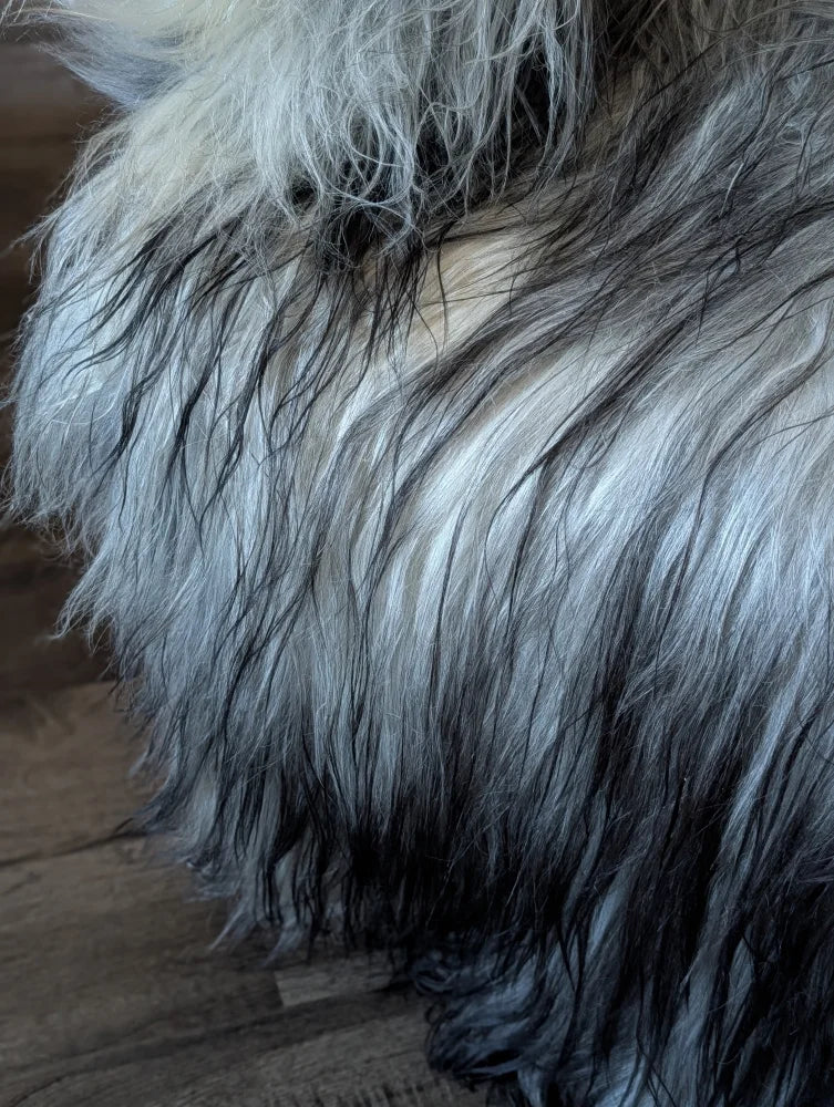 A plush long wool icelandic throw in silver and black gradient perfect for cozying up with natural grey sheepskins