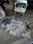 A massive 57 by 37 inch fall3 icelandic sheepskin rug with natural grey long wool icelandic fur on wooden floor