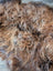A plush massive natural dark rusty icelandic sheepskin rug with curly wool icelandic soft shaggy texture