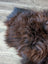 A plush shaggy brown wool icelandic sheepskin rug with natural shade variations and soft textured surface