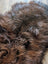 A massive soft shaggy brown icelandic sheepskin rug with natural color variations and wool icelandic texture