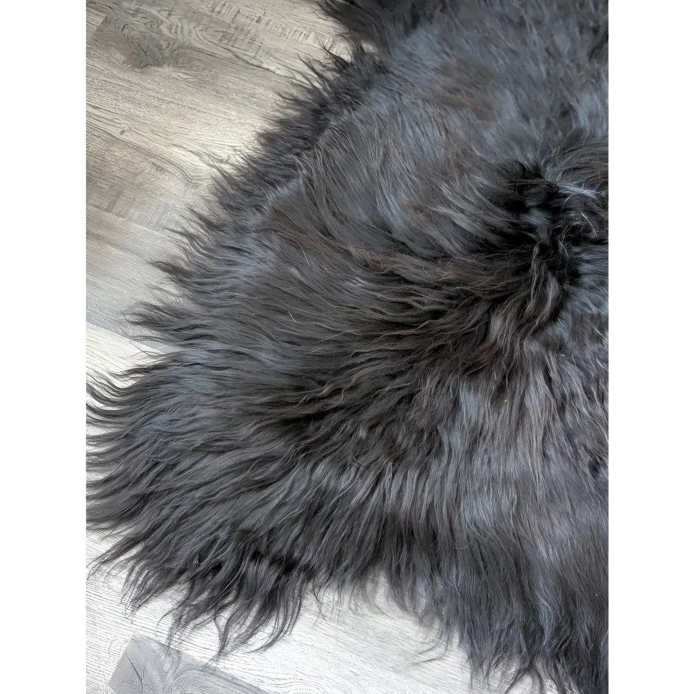 Massive 57x32 black Icelandic sheepskin rug with soft, thick fur on wood floor