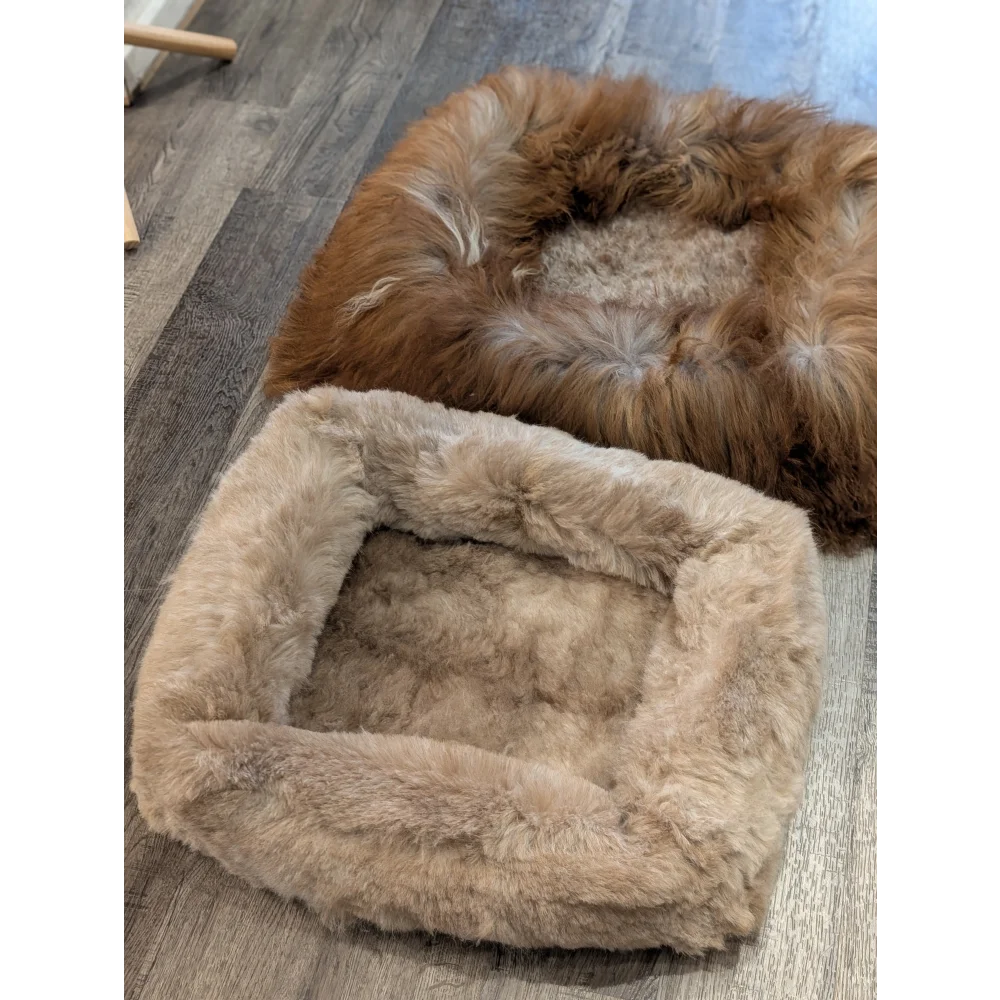 Cozy tan faux fur sheepskin pet bed with plush interior and rounded corners